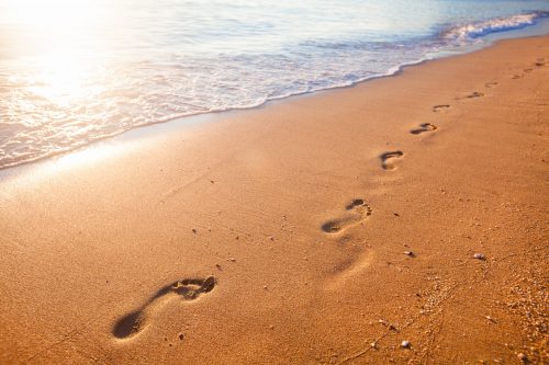 Beach, Wave And Footprints At Sunset Time